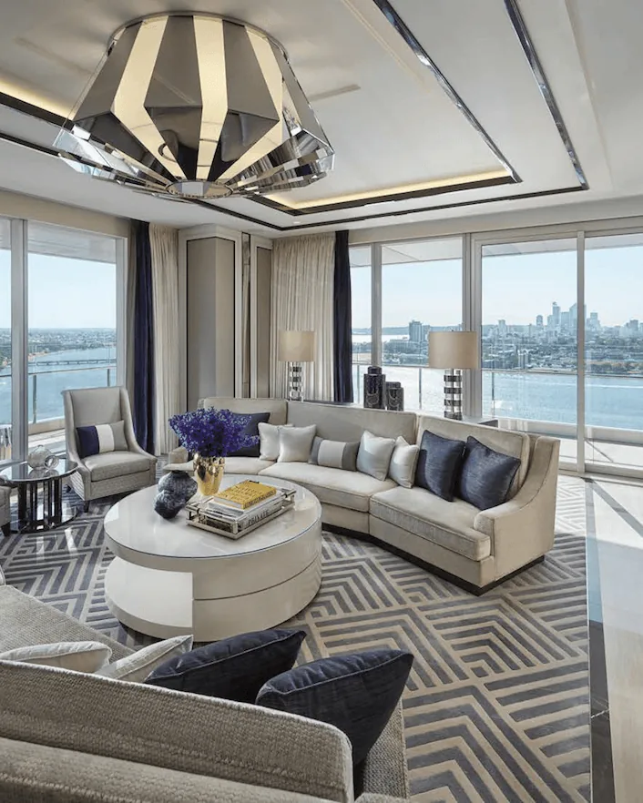 Hotel suite living area with patterned carpet and river views